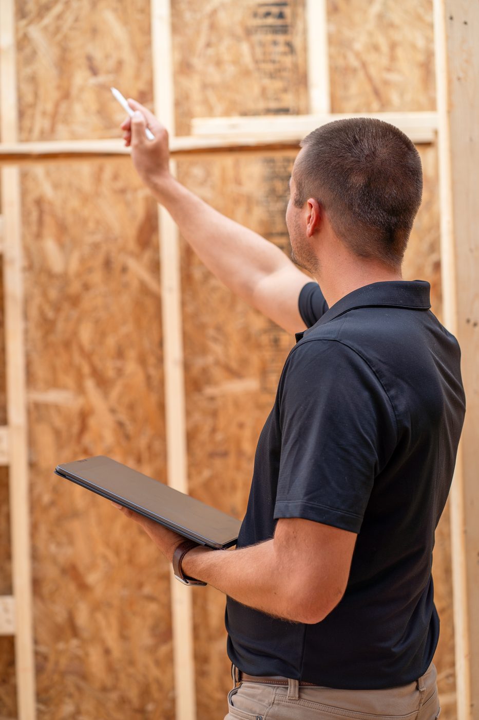 Cody reviewing roof framing inside a house under construction