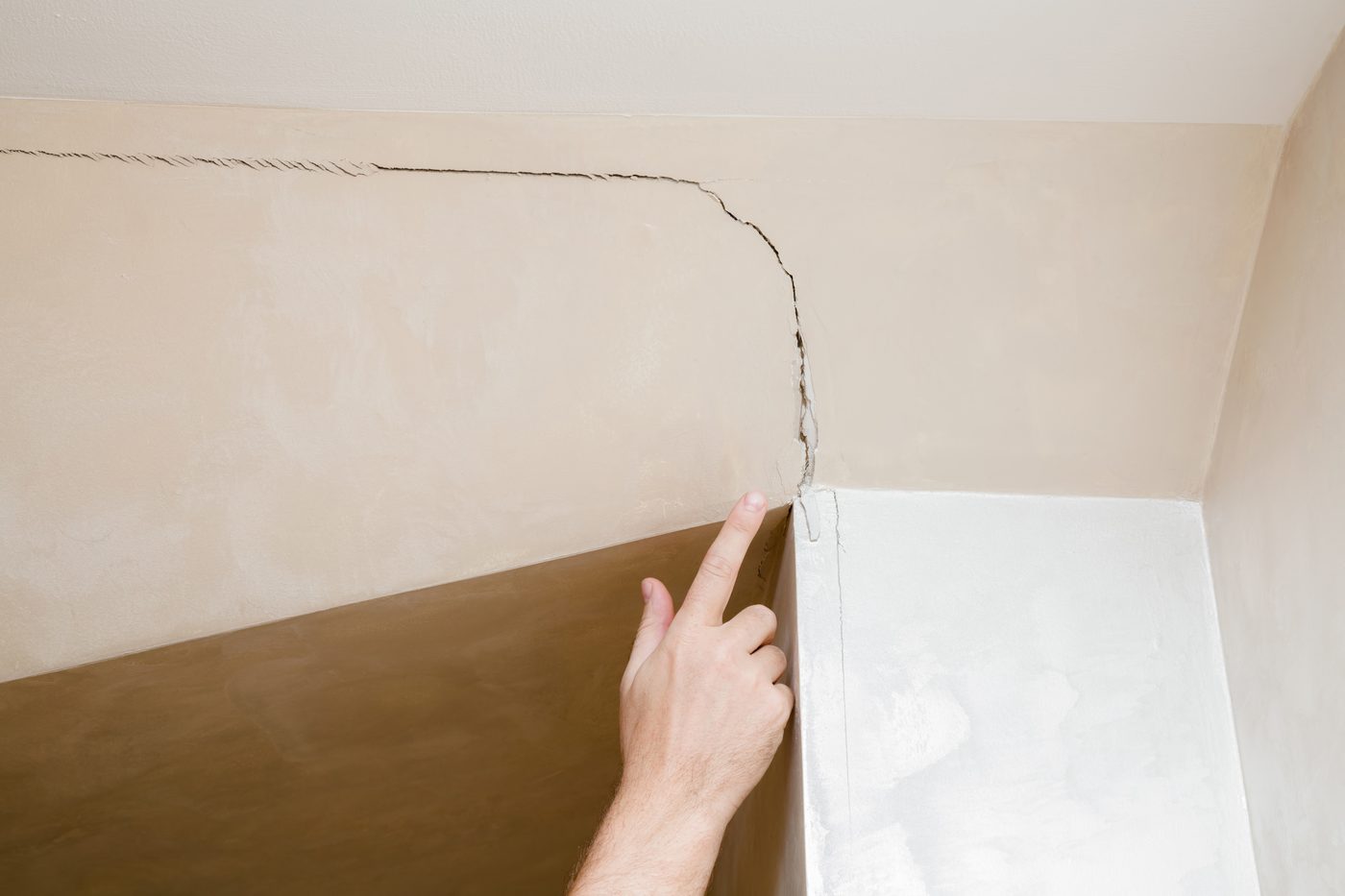 Diagonal drywall crack of the kind Oakline diagnoses during structural inspections